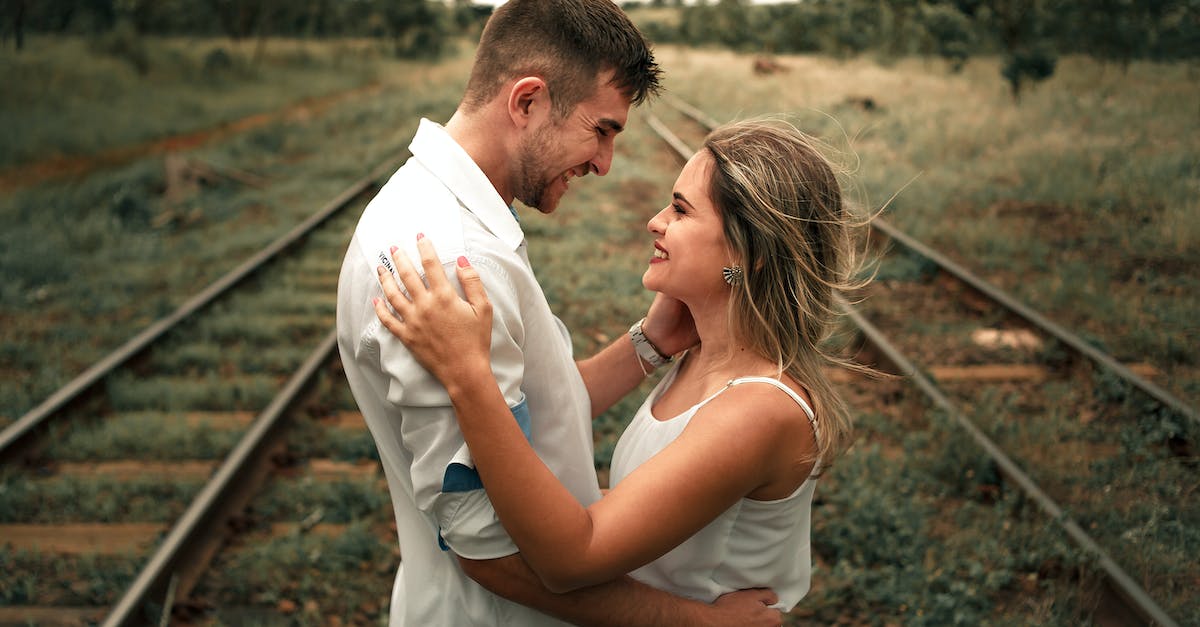 Do Tracking Disruptors Affect Missiles? - Smiling Man and Woman Facing Each Other Beside Railway Train