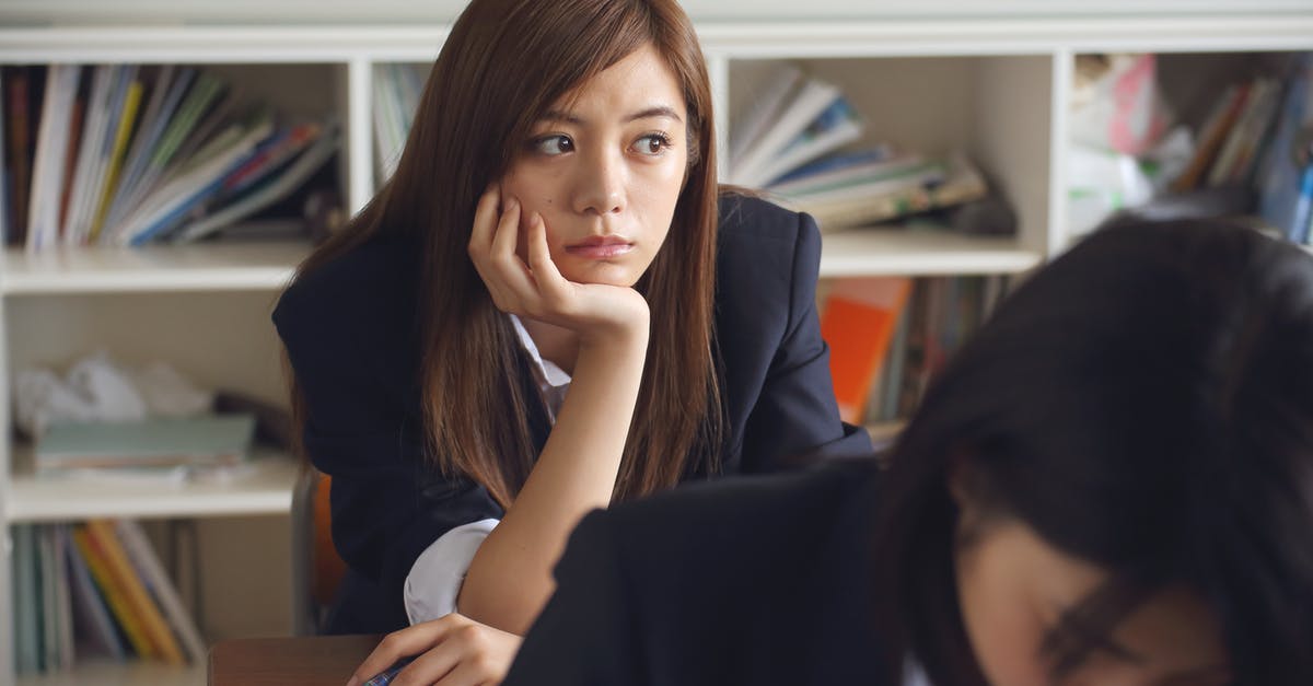 Do we ever learn why the Locust Queen looks so human? - Woman Holding Chin Sitting Beside Table in Room Do we ever learn why the Locust Queen looks so human? - Woman Holding Chin Sitting Beside Table in Room