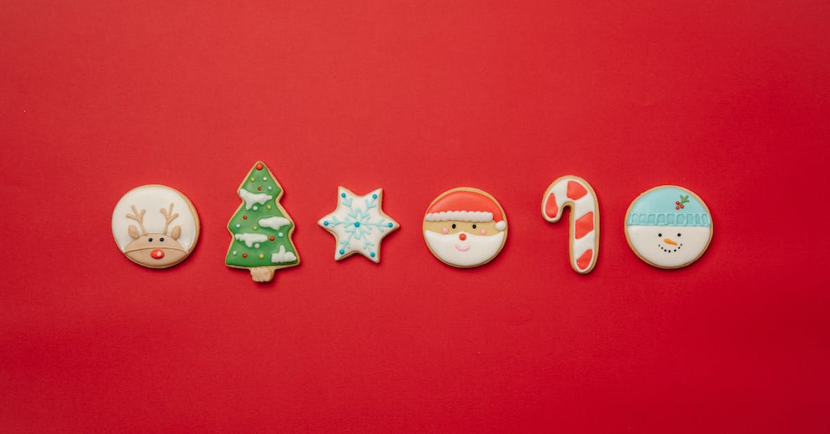 Do you find sugar cane near water? [duplicate] - Top view of assorted Christmas cookies of different shapes decorated with colorful icing and arranged in row on red background