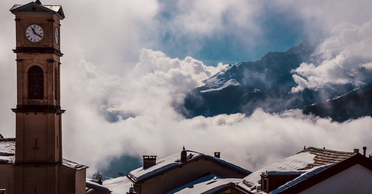 Do you get a 5,000 Bell reward every time you provide the Dream Suite with a new version of your town? - Clock tower with cross against foggy mountain in winter town