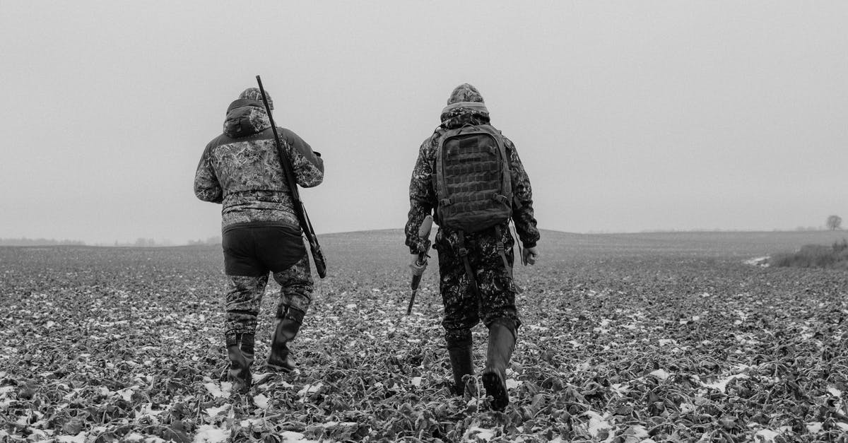 Do you get your Hunters Axe back? - Grayscale Photo of Two Men Carrying Rifles