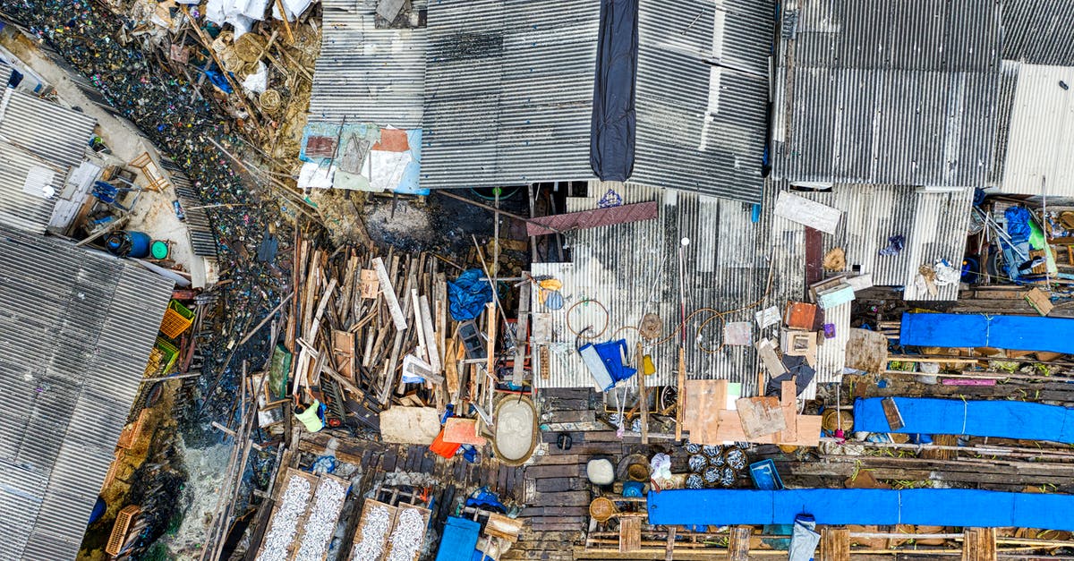 Do you need trash bins in queue lines? - Grungy buildings near dump in ghetto