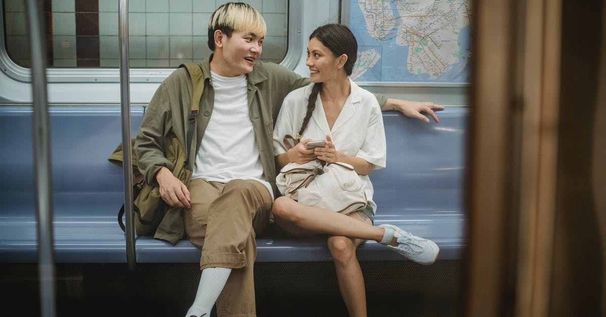 Does 'scenery' affect anything other than guests thoughts on the ride? - Happy young ethnic couple sitting in train and talking Does 'scenery' affect anything other than guests thoughts on the ride? - Happy young ethnic couple sitting in train and talking