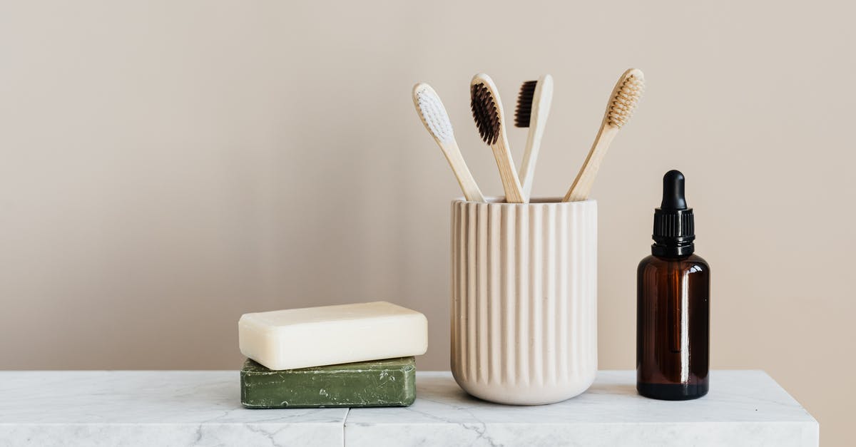 Does 'wasting' ammution reduces weight? - Collection of organic soaps and bamboo toothbrushes in ceramic minimalism style holder placed near renewable glass bottle with essential oil on white marble tabletop against beige wall