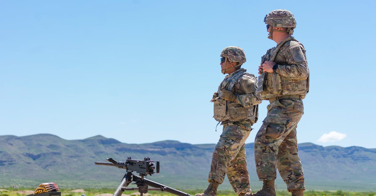 Does a Hazmat Vest make your soldier immune to Chryssalid poison? - Man in Camouflage Uniform Standing Near an Automatic Weapon