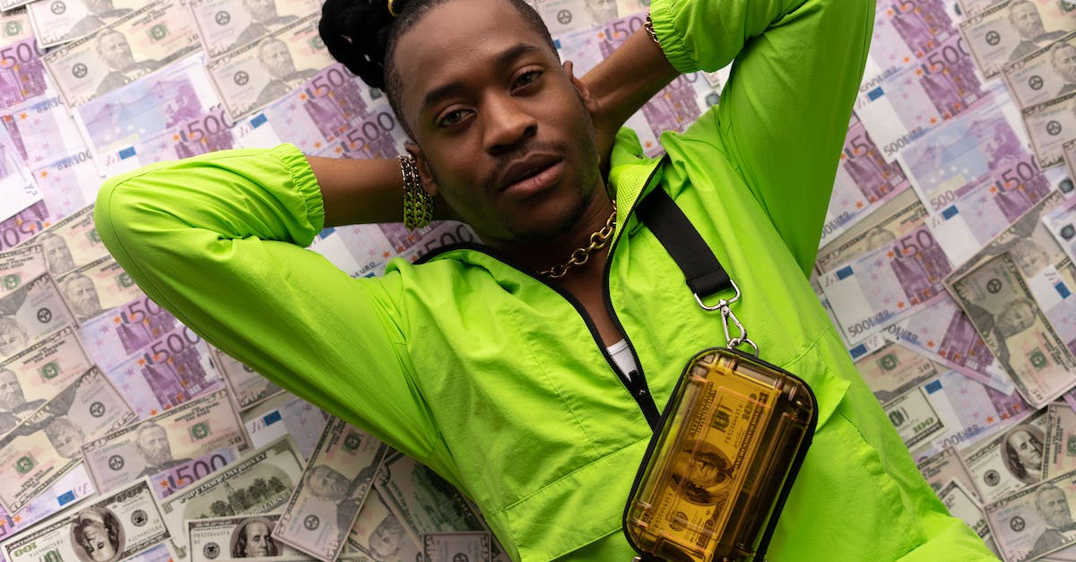 Does an airstrike bring more money than shooting down over water? - Man in Green Jacket Lying Down on Money