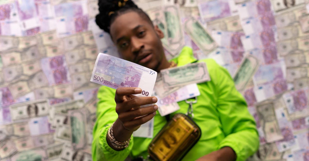 Does an airstrike bring more money than shooting down over water? - Man in Green Jacket Holding Banknote