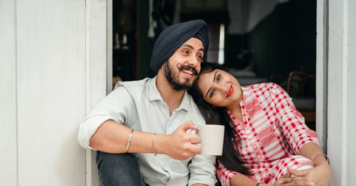 Does anyone tell you about the statues? - Positive married couple relaxing on threshold of house Does anyone tell you about the statues? - Positive married couple relaxing on threshold of house