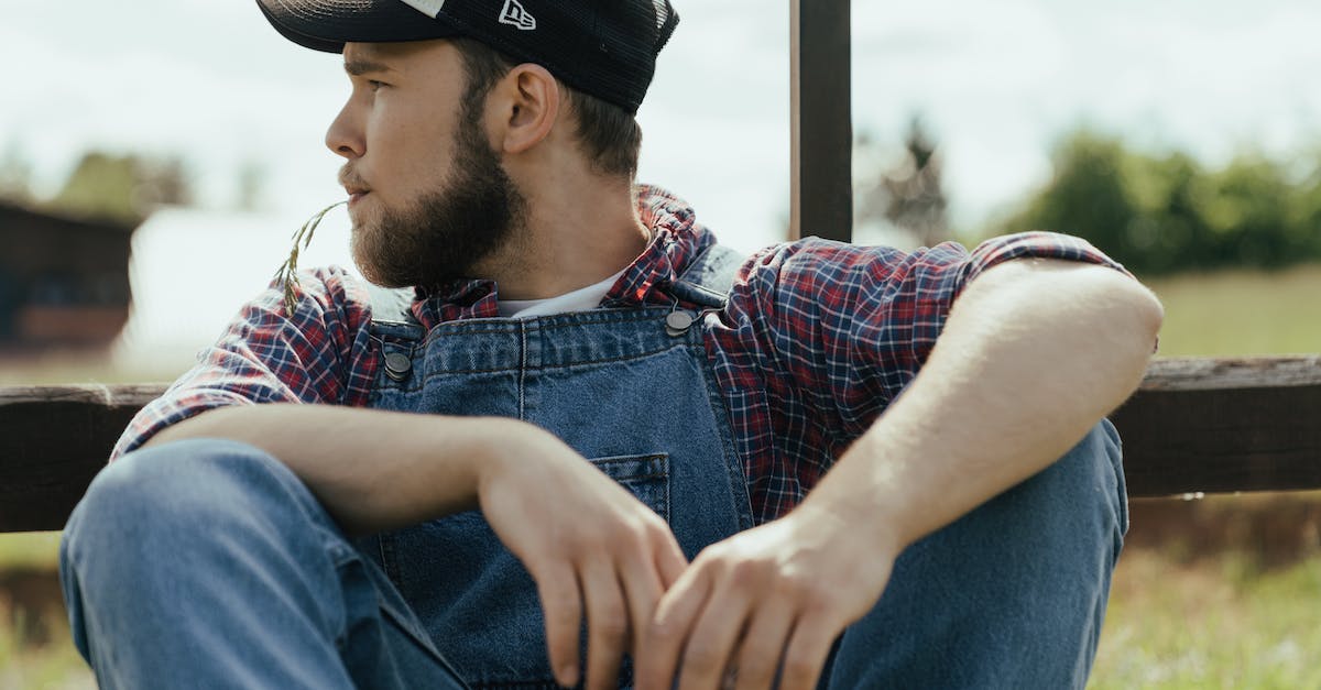 Does Apollo's passive break cap? - Man in Blue Denim Vest and Black Cap Sitting on Brown Wooden Chair