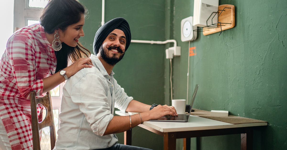 Does ball type affect the distance a captured Pokemon can be thrown? - Smiling young Indian woman in casual clothes caring for positive husband working on laptop from home