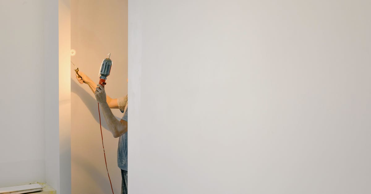 Does bankruptcy remove all buildings based on when their construction started or finished? - Crop man painting walls in room