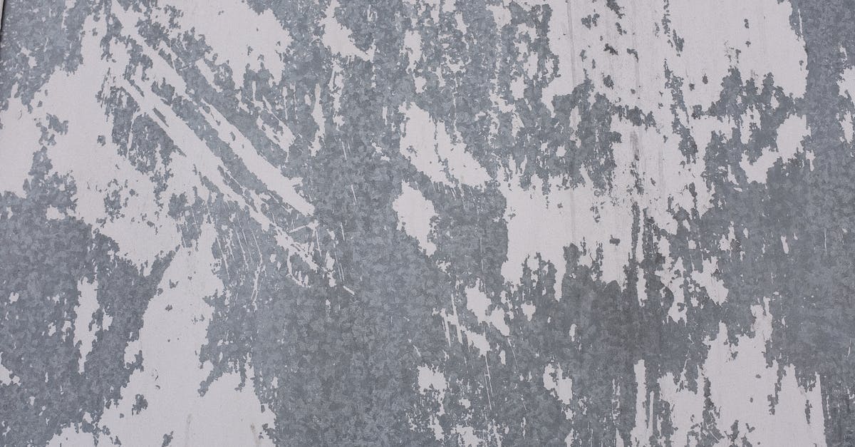 Does bankruptcy remove all buildings based on when their construction started or finished? - Old shabby metal surface with white paint on wall of old building