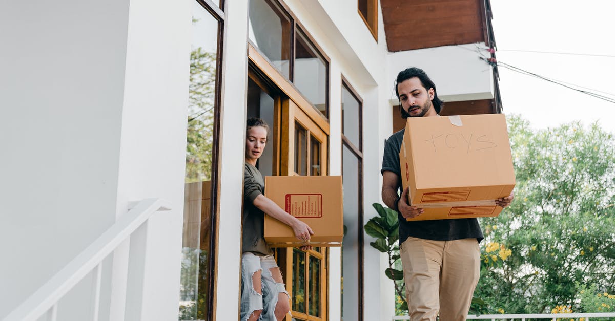 Does card shop change if I move down arena? - Couple carrying carton boxes while moving out of old home