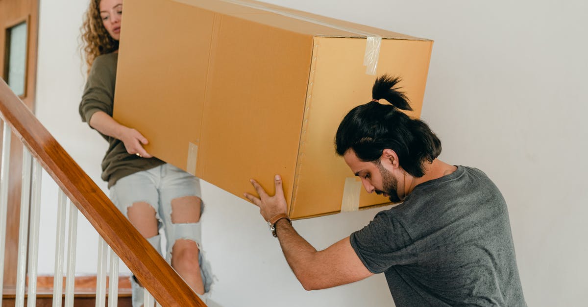 Does card shop change if I move down arena? - Couple carrying box down stairs in new apartment