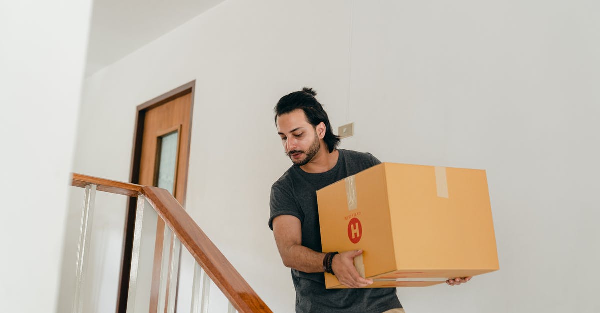 Does card shop change if I move down arena? - Adult man carrying box down stairs