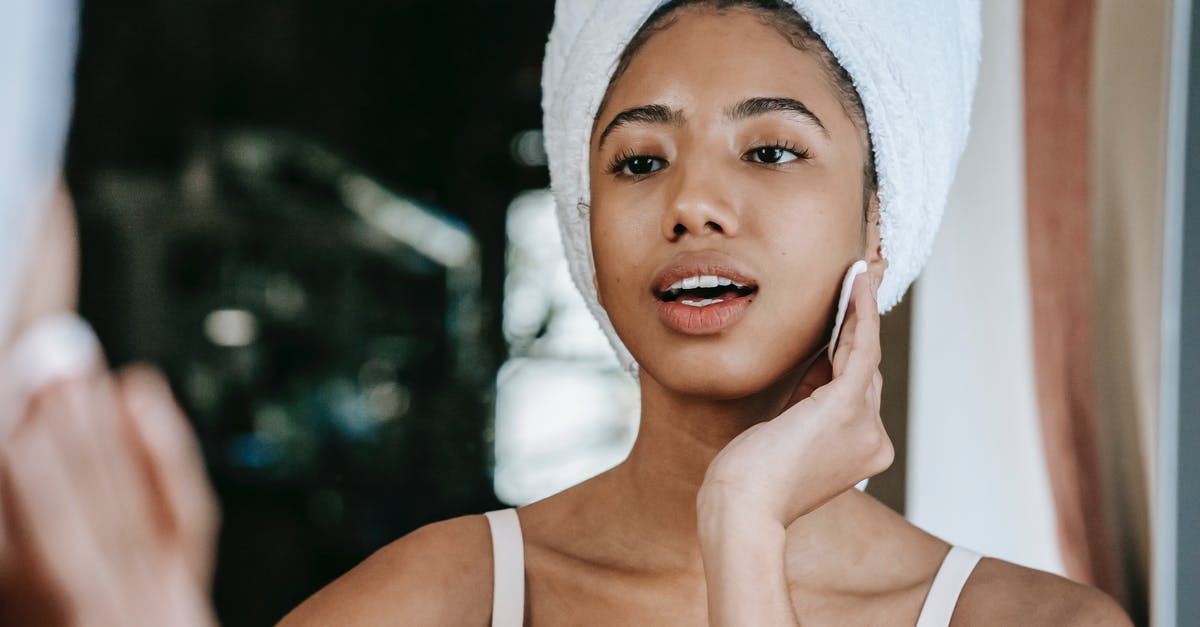 Does cleanse remove Zed's ultimate? - Ethnic female with mouth opened cleaning face with cotton pad while looking at mirror during daily beauty care Does cleanse remove Zed's ultimate? - Ethnic female with mouth opened cleaning face with cotton pad while looking at mirror during daily beauty care