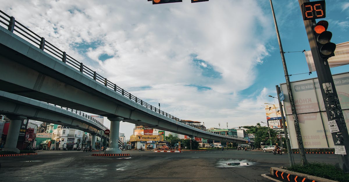 Does construction stop after a raid - Low angle of empty asphalt crossroad with red traffic light with timer in center of city Does construction stop after a raid - Low angle of empty asphalt crossroad with red traffic light with timer in center of city