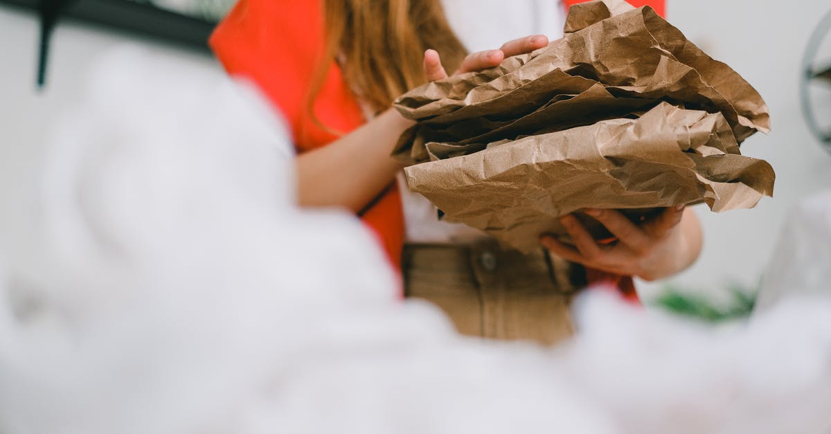Does damage over time stack and is it affected by sneak/crit bonus? - Low angle of crop anonymous female standing with heap of crumple paper while separating trash for recycling