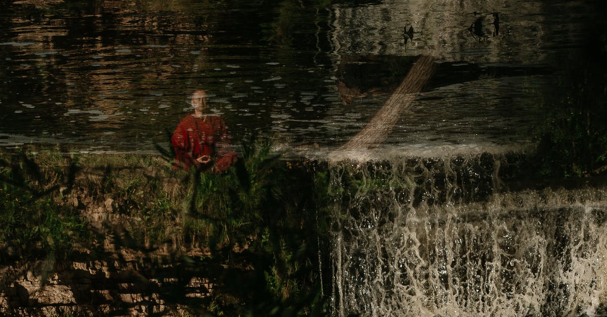 Does Dark Souls III follow Dark Souls and Dark Souls II in the storyline? - Person in Red Jacket Standing on Water