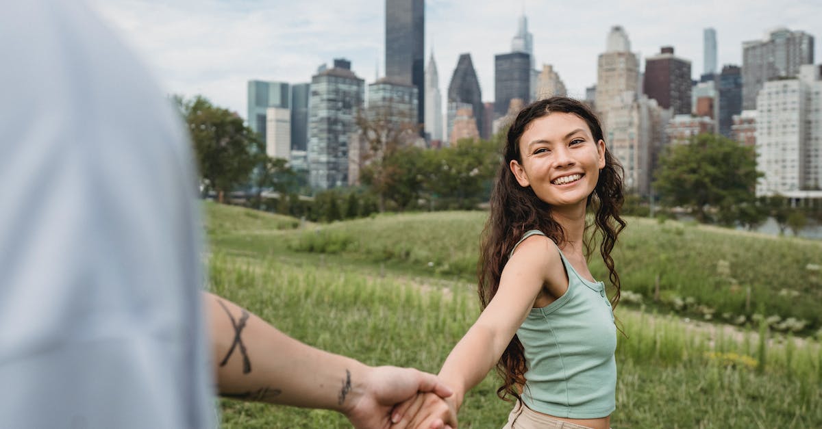 Does dying at the tower affect the bounties? - Cheerful ethnic woman spending pleasant time with crop boyfriend in green park in big modern city Does dying at the tower affect the bounties? - Cheerful ethnic woman spending pleasant time with crop boyfriend in green park in big modern city