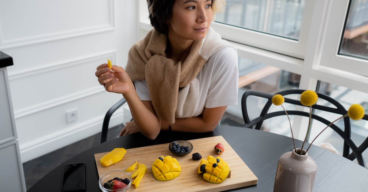 Does eating certain foods make me bigger? - Woman Eating Fruits from Wooden Chopping Board