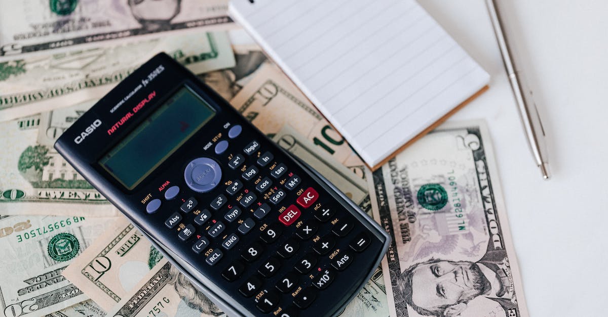 Does %EXP and % Magic Find from my follower count towards my character? [duplicate] - From above electronic calculator and notepad placed over United States dollar bills together with metallic pen for budget planning and calculation