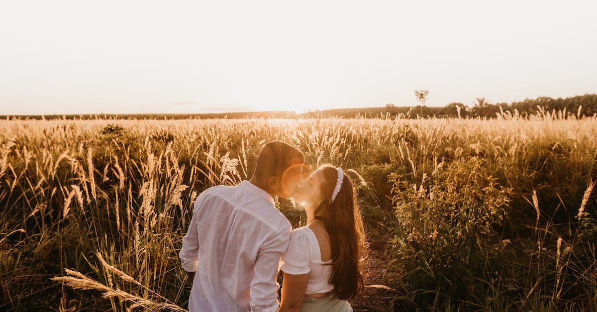 Does hair grow back? - High angle back view of romantic couple with closed eyes kissing tenderly in grassy field at sundown in countryside Does hair grow back? - High angle back view of romantic couple with closed eyes kissing tenderly in grassy field at sundown in countryside