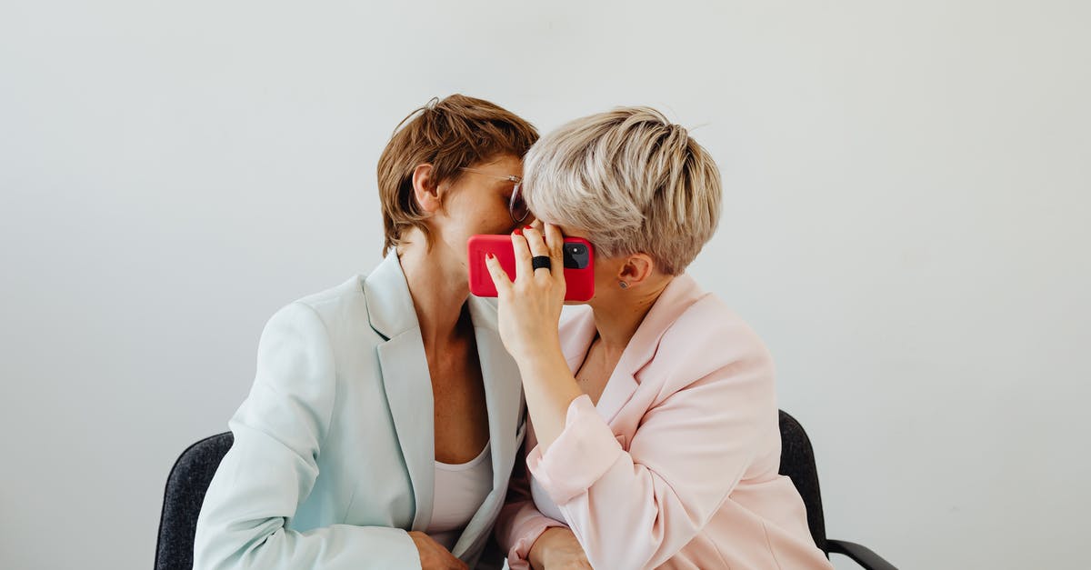 Does hiding in dead bodies work against enemies? - Women in Blazers Sitting Beside and Hiding a Kiss Behind Red Mobile Phone Does hiding in dead bodies work against enemies? - Women in Blazers Sitting Beside and Hiding a Kiss Behind Red Mobile Phone