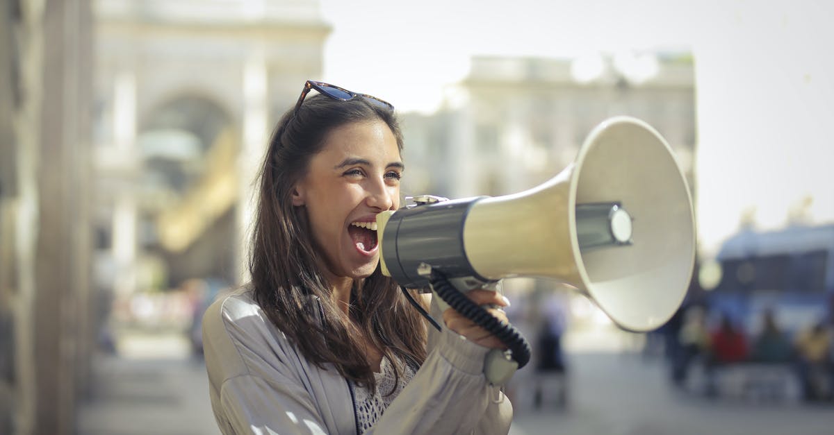 Does Inspiring Presence affect Threatening Shout - Demoralize - Cheerful young woman screaming into megaphone