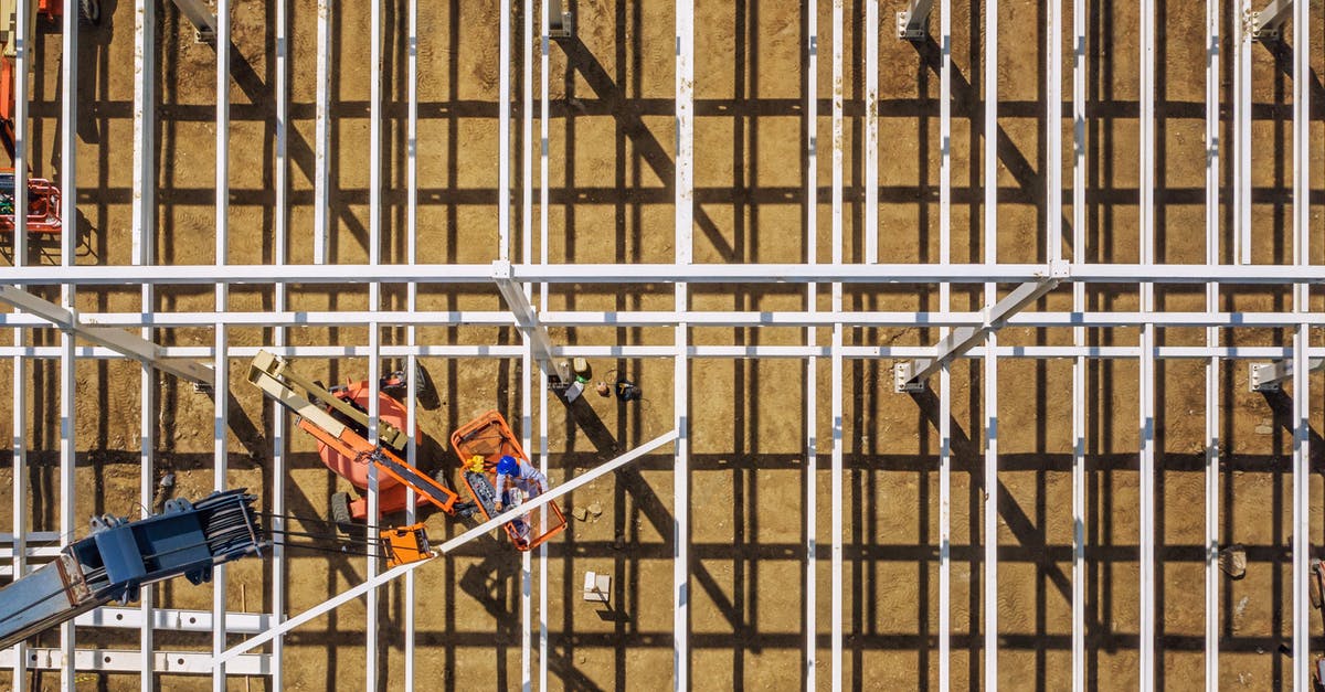 Does installing the free official DLCs provide you with inproportionately powerful equipment early on? - Top view of mechanical machines providing frame of future building in sandy quarry on sunny day