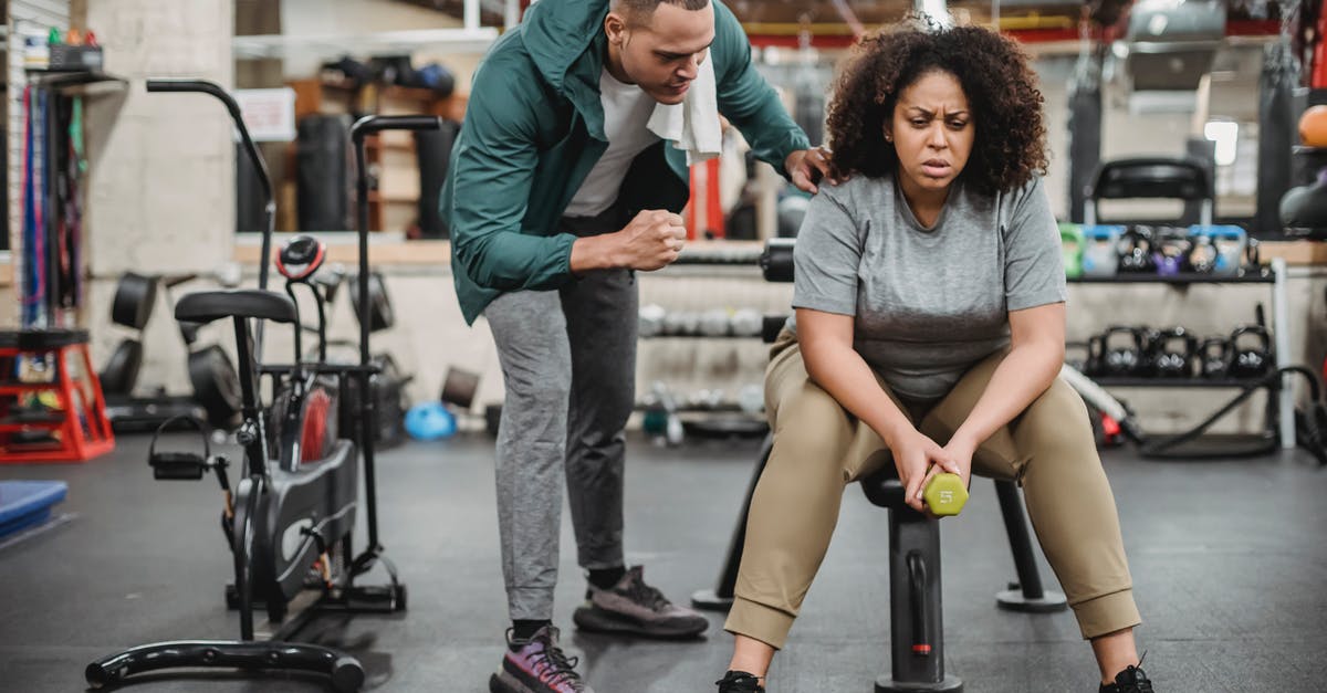 Does it help my team's gym if I train there, but lose? - Personal male trainer with overweight female client in fitness center Does it help my team's gym if I train there, but lose? - Personal male trainer with overweight female client in fitness center