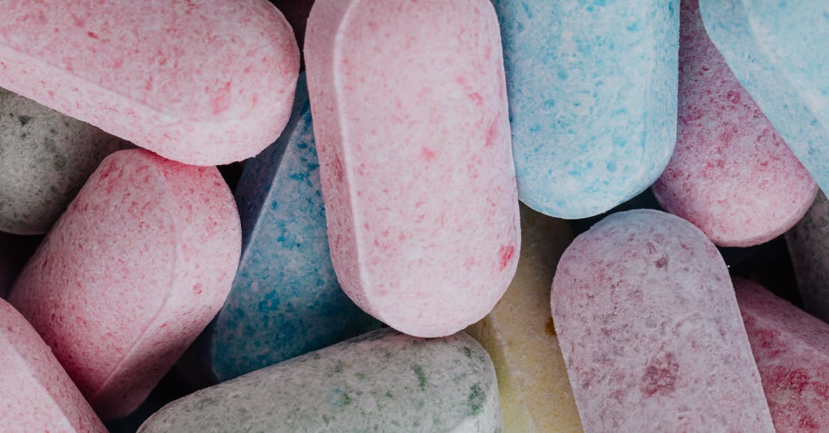 Does it make a difference to CP if you feed candies before or after evolving? - Top view of full frame background of multicolored sweet dragess composed in heap Does it make a difference to CP if you feed candies before or after evolving? - Top view of full frame background of multicolored sweet dragess composed in heap