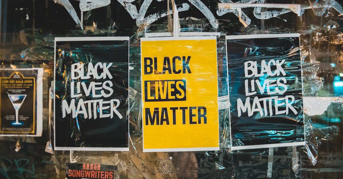 Does lane choice matter? - Slogan Black Lives Matter on small rectangular paper sheets on surface of painted glass