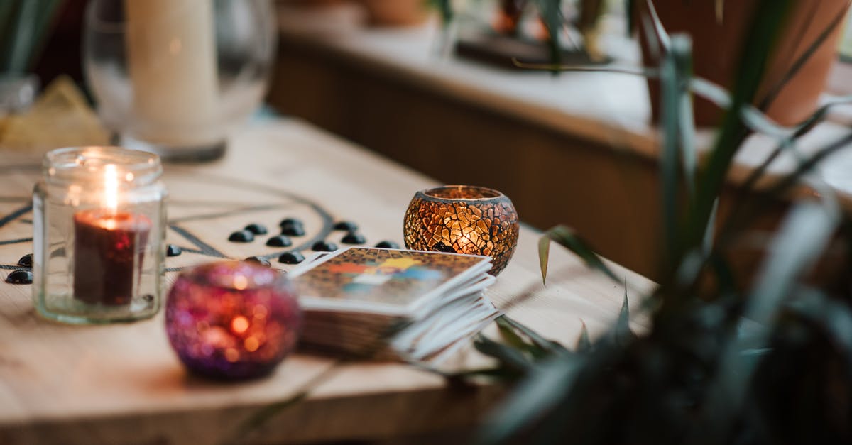 Does lava set signs on fire? - Luminous candles in holders near tarot cards on table with oracle symbol at home Does lava set signs on fire? - Luminous candles in holders near tarot cards on table with oracle symbol at home