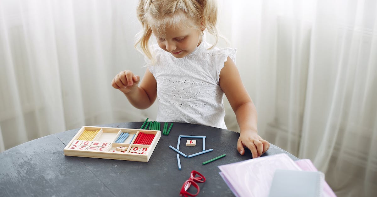Does leaving a bot game count as an abandon? - Blond little girl standing while playing with puzzle in living room at home and counting sticks different colors during weekend