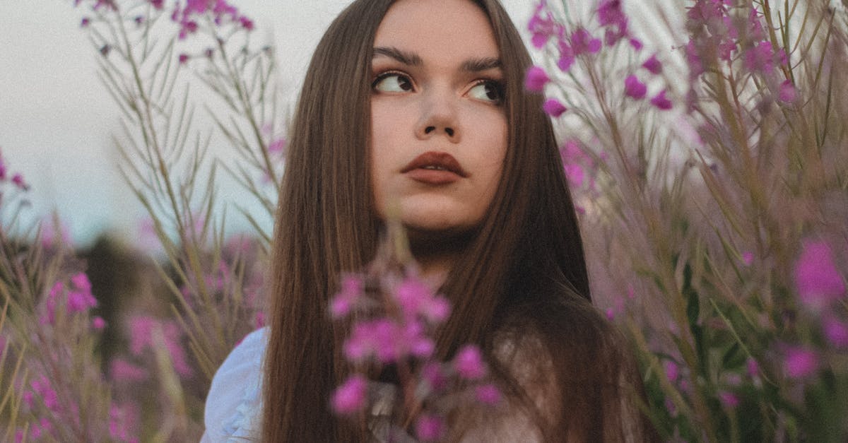 Does Loot Redistribute Among Storages - Young Beautiful Woman Standing among Blooming Flowers in Meadow