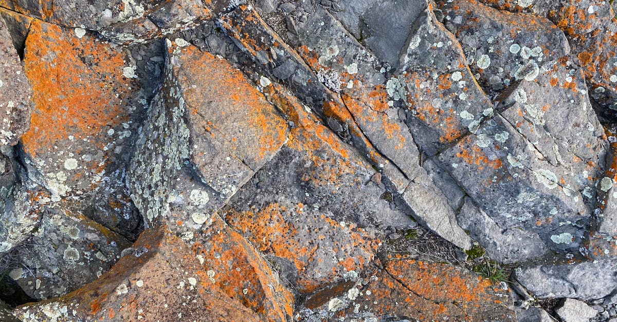 Does Mercy's damage buff affect structures? [duplicate] - Top view of rough natural rock surface with cracks and orange rust as abstract  background