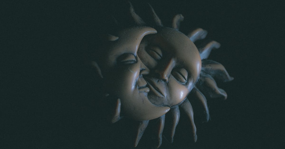 Does night and day affect maps? - Creative clay artwork representing friendly artificial sun and moon faces with beams smiling with closed eyes on black background