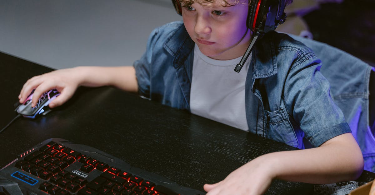 Does Optifine Make Minecraft Run Smoother Or Slower On A Low-End Gaming PC? - A Boy Wearing Headphones Using a Computer  Keyboard