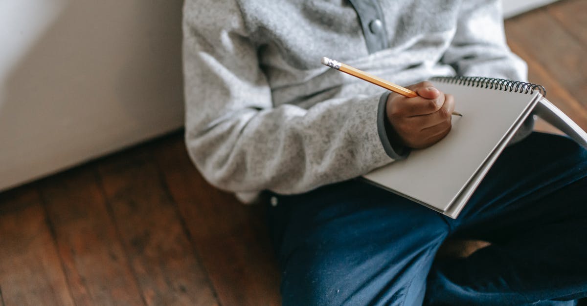 Does Playstation Plus only works when is a primary account? - From above faceless child with pencil and notebook taking notes while sitting on floor