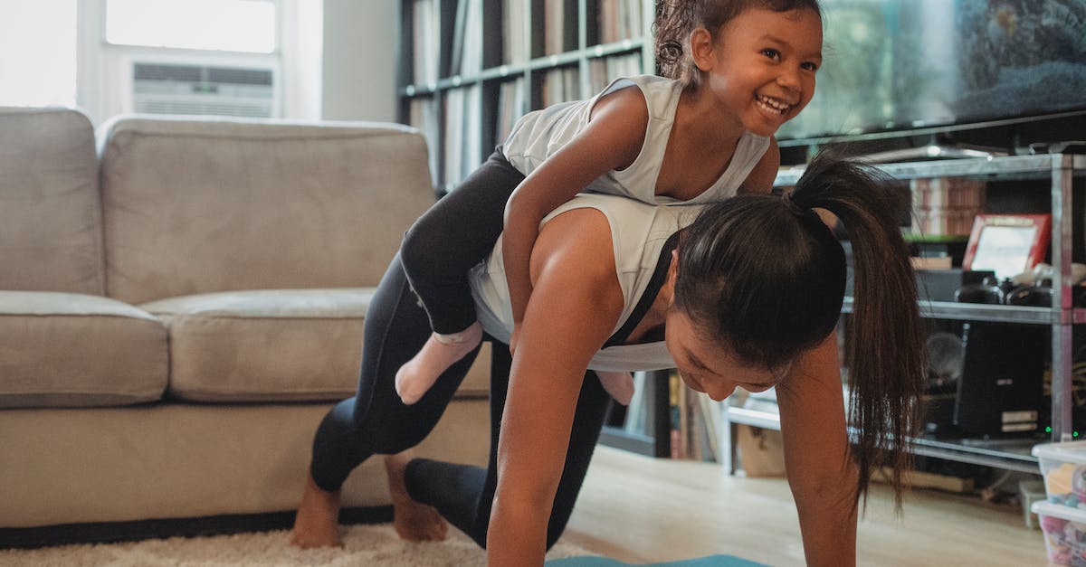 Does Pokerus affect Super Training? - Young Asian woman piggybacking smiling daughter while exercising at home
