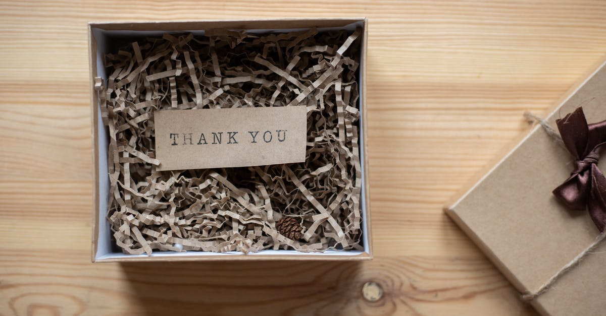 Does pressing L give you items faster? - Top view of opened carton present box with small postcard with Thank You inscription and paper stuffing on wooden table