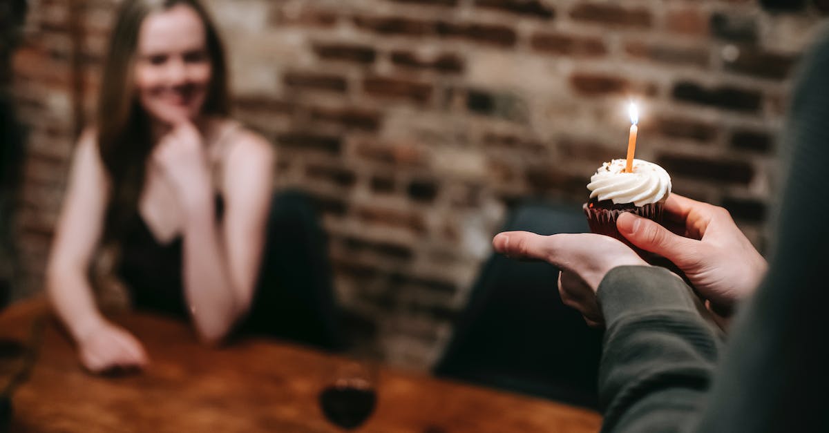 Does "Happy Birthday Diablo III" Buff affect Kadala? - Man with cupcake celebrating occasion with girlfriend in cafe