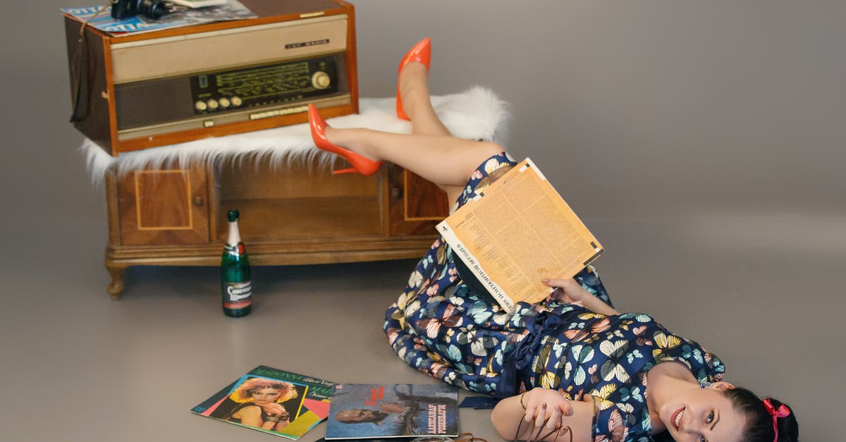 Does radio studio upgrade increases happiness level? - Happy woman lying on floor near vintage disks and record player Does radio studio upgrade increases happiness level? - Happy woman lying on floor near vintage disks and record player