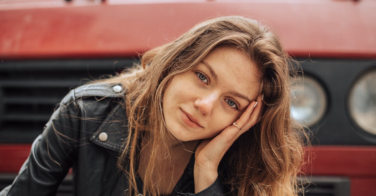 Does Red Buff stack and how long does it last? - Smiling Young Woman with Tilted Head in Front of Big Red Car Hood