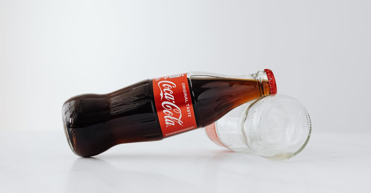 Does Red Orchestra 2 contain Single and Multiplayer? - Closed bottle of soft drink leaned on empty bottle lying on white reflective surface