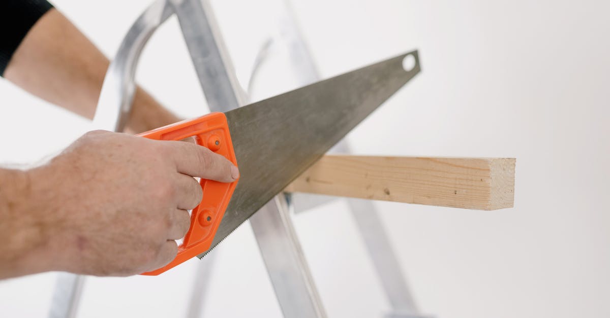 Does stoking the fire do anything once the builder has recovered? - Crop man sawing wooden plank at home Does stoking the fire do anything once the builder has recovered? - Crop man sawing wooden plank at home