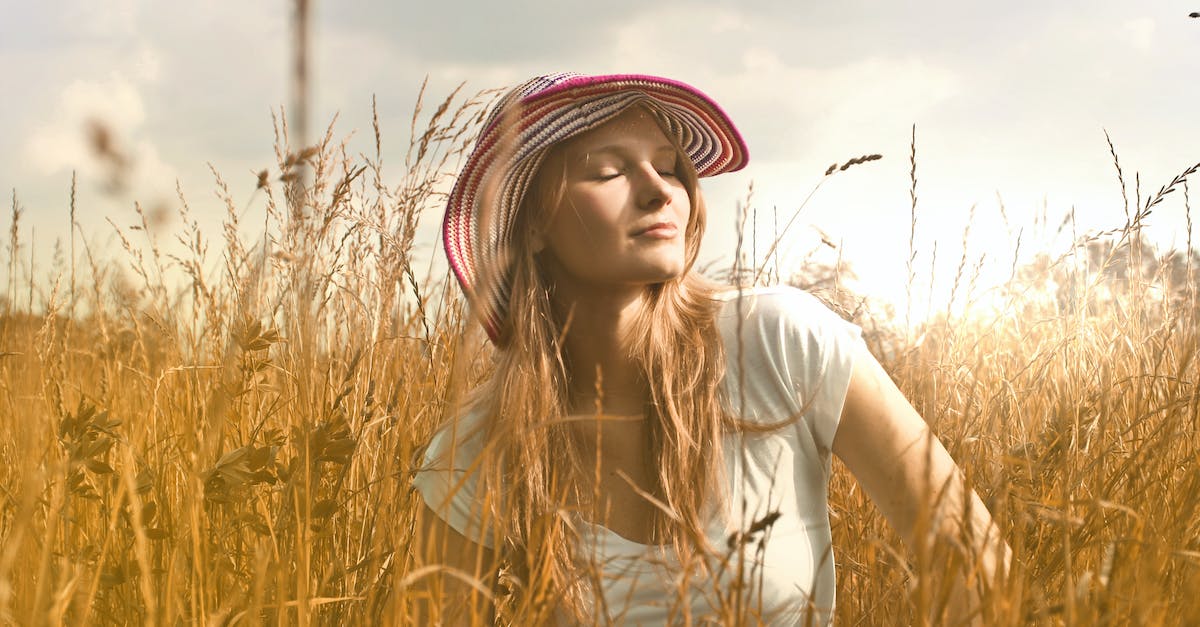 Does straw hat and other overheat-slowing items increase heat drain during winter? - Woman Wearing White Top and Red and White Sunny Hat