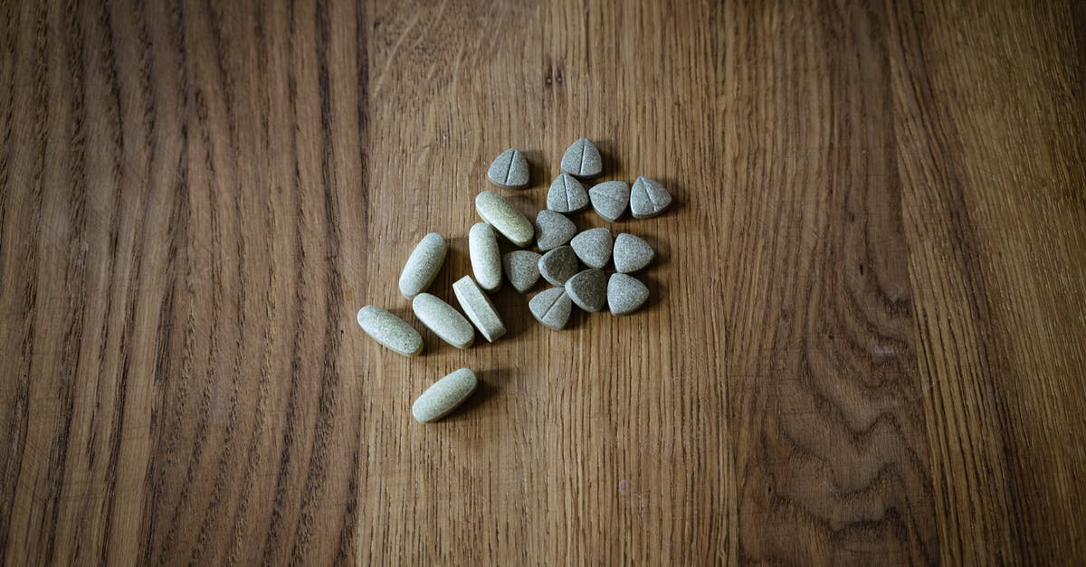 Does the Advanced Warfare Center healing bonus stack with the bonus from HQ? - From above of set of different assorted medical pills arranged on lumber surface