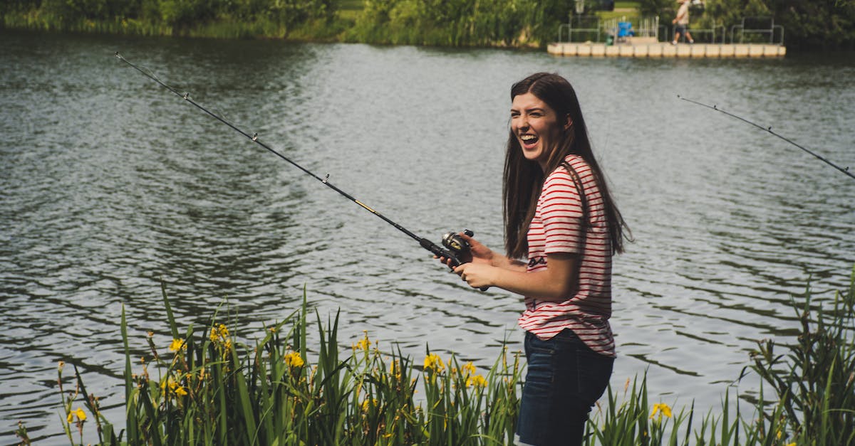 Does the Angler NPC have spawn requirements? - Woman in Red Striped Shirt and Blue Denim Shorts Holding Fishing Rod